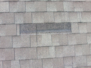 missing shingles on a roof in Grove, OK, that needs repairs.