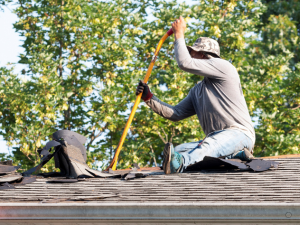 Professional roofing contractor working on a Pryor home